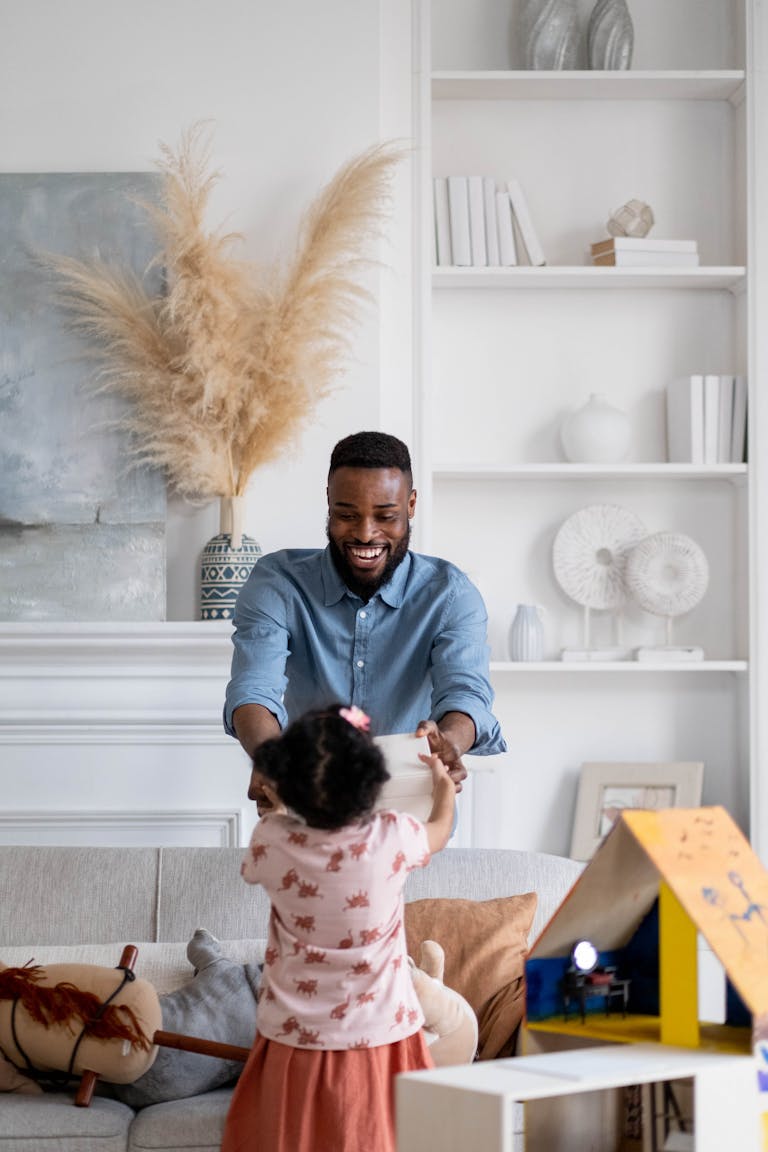 Joyful father and daughter bonding indoors, playing together.