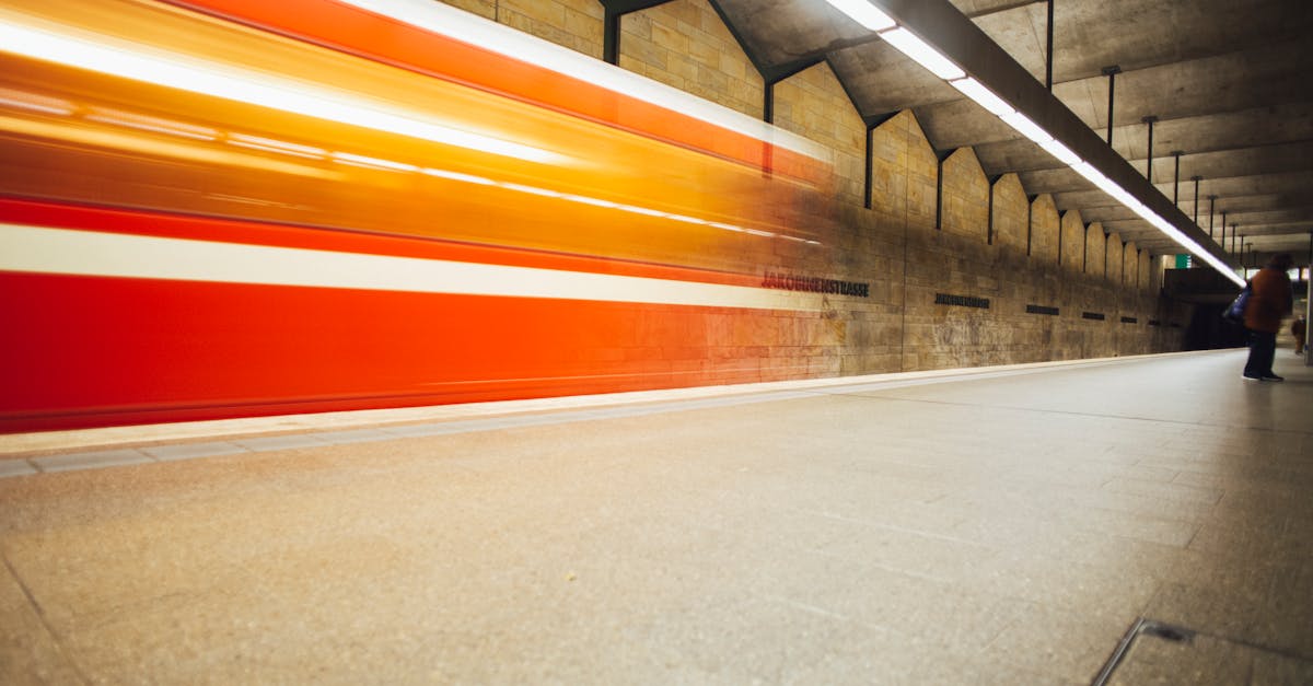 Long exposure of a subway train speeding through an underground station, capturing motion and energy.